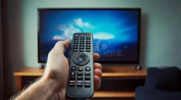 Realistic close-up shot of hands tuning a satellite receiver with a remote control, displaying a clear frequency settings menu on a modern television screen, good lighting, high resolution, slightly blurred background
